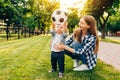 Happy young mom and her little son play soccer together outdoors Royalty Free Stock Photo