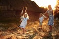 Happy young moms playing with their kids outdoors in summer. Happy family time together concept. selective focus Royalty Free Stock Photo