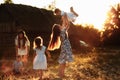 Happy young moms playing with their kids outdoors in summer. Happy family time together concept. selective focus Royalty Free Stock Photo