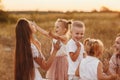 Happy young moms playing with their kids outdoors in summer. Happy family time together concept. selective focus Royalty Free Stock Photo