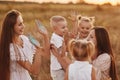 Happy young moms playing with their kids outdoors in summer. Happy family time together concept. selective focus Royalty Free Stock Photo