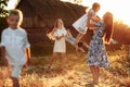 Happy young moms playing with their kids outdoors in summer. Happy family time together concept. selective focus Royalty Free Stock Photo