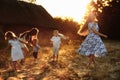 Happy young moms playing with their kids outdoors in summer. Happy family time together concept. selective focus Royalty Free Stock Photo