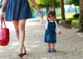 Happy young mother and adorable toddler girl walking through sum Royalty Free Stock Photo