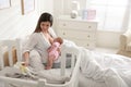 Happy young mother breastfeeding newborn baby at home Royalty Free Stock Photo