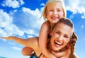 Happy young mother and child on beach having fun time Royalty Free Stock Photo