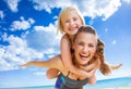 Happy young mother and child on beach having fun time Royalty Free Stock Photo