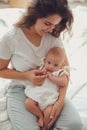 Happy young mother with cute baby on bed at home Royalty Free Stock Photo