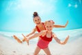 Happy young mother and daughter on seacoast having fun time Royalty Free Stock Photo
