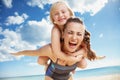 Happy young mother and daughter on seacoast rejoicing Royalty Free Stock Photo