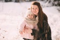 Happy young mother with daughter walk in the winter park. Close up. Portrait happy family outdoors Royalty Free Stock Photo