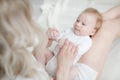 A happy young mother gently holds her newborn son in her arms Royalty Free Stock Photo