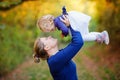 Happy young mother having fun cute toddler daughter, family portrait together. Woman with beautiful baby girl in nature Royalty Free Stock Photo