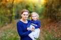 Happy young mother having fun cute toddler daughter, family portrait together. Woman with beautiful baby girl in nature Royalty Free Stock Photo