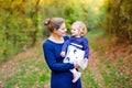 Happy young mother having fun cute toddler daughter, family portrait together. Woman with beautiful baby girl in nature Royalty Free Stock Photo