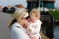 Happy young mother having fun cute toddler daughter, family portrait together. Woman with beautiful baby girl walking in Royalty Free Stock Photo