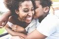 Happy young mother having fun with her child in summer day - Son kissing his mum outdoor - Family lifestyle, motherhood, love and Royalty Free Stock Photo