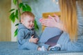 Happy young mother and her baby son playing togerher Royalty Free Stock Photo