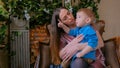 Happy young mother and her baby son sitting togerher Royalty Free Stock Photo