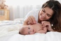 Happy young mother with cute baby on bed at home Royalty Free Stock Photo