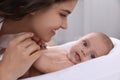 Happy young mother with her cute baby on bed at home, closeup Royalty Free Stock Photo