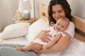 Happy young mother with cute baby on bed at home Royalty Free Stock Photo