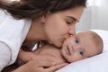 Happy young mother with her cute baby on bed at home, closeup Royalty Free Stock Photo