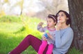 Happy young mother and her daughter blowing soap bubbles Royalty Free Stock Photo