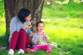 Happy young mother and her daughter blowing soap bubbles Royalty Free Stock Photo