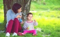 Happy young mother and her daughter blowing soap bubbles Royalty Free Stock Photo