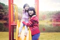 Mother and daughter smiling on slide Royalty Free Stock Photo
