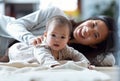 Happy young mother with his baby playing together and having fun at home Royalty Free Stock Photo