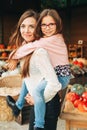 Happy young mother holding daughter on her back Royalty Free Stock Photo