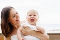 Happy and young mother holding her baby Royalty Free Stock Photo