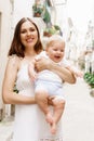 Happy and young mother holding her baby Royalty Free Stock Photo