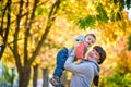 Happy young mother holding sweet toddler boy, family having fun together outside on a nice sunny autumn day. Cute adorable kid and Royalty Free Stock Photo