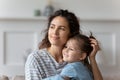 Happy mom and little daughter dreaming at home together Royalty Free Stock Photo