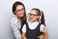 Happy young mother and laughing kid in fashion glasses hugging Royalty Free Stock Photo