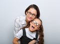 Happy young mother and lauging kid in fashion glasses hugging on empty copy space Royalty Free Stock Photo