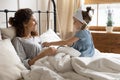 Playful small child girl playing doctor patient with mother.