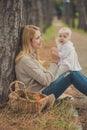 Happy young mother mam sylish dressed posing with baby daughter wearing pink dress lovely spending lifetime together family sittin