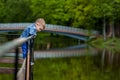 Happy young mother playing and having fun with her little baby son on warm spring or summer day in the park. Happy family concept Royalty Free Stock Photo