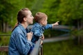 Happy young mother playing and having fun with her little baby son on warm spring or summer day in the park. Happy family concept Royalty Free Stock Photo