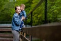 Happy young mother playing and having fun with her little baby son on warm spring or summer day in the park. Happy family concept Royalty Free Stock Photo