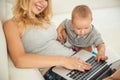 Happy young mother playing with her son the couch Royalty Free Stock Photo