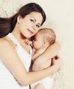 Happy young mother sleeping with baby on bed at home, t Royalty Free Stock Photo