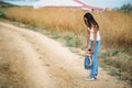 Happy young mother with a small daughter in hands, who is trying to make her first steps, outdoors background Royalty Free Stock Photo