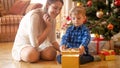 Happy young mother and toddler son are excited of Christmas gifts Royalty Free Stock Photo