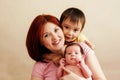 Portrait of happy mixed race family: mother with two children, infant baby girl and toddler son Royalty Free Stock Photo