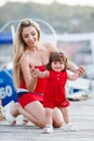 Happy young mother with a young daughter near Yacht Club Royalty Free Stock Photo